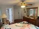 Comfortable bedroom with a large dresser, closet, ceiling fan, and en suite bathroom at 8150 Braddock Cir # 4, Port Richey, FL 34668