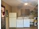 Laundry room equipped with a washer, dryer, refrigerator, and sink at 8150 Braddock Cir # 4, Port Richey, FL 34668