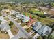 Overhead view showcasing the home's location on a golf course, surrounded by lush landscaping and neighborhood at 9089 Penelope Dr, Weeki Wachee, FL 34613