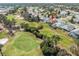 Panoramic aerial shot shows the house set on a golf course in a tranquil community near a lake at 9089 Penelope Dr, Weeki Wachee, FL 34613