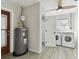 The laundry room features a water heater, washer, dryer, and ceiling fan at 980 Sunrise Dr, Tarpon Springs, FL 34689