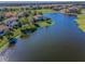 Picturesque aerial view of waterfront homes and golf course, showcasing lakeside living at its finest at 10309 Altrara Way, Trinity, FL 34655