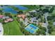 Aerial view of community with pool, tennis courts, and surrounding golf course at 10309 Altrara Way, Trinity, FL 34655