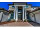 Close up of elegant home featuring prominent pillars and a manicured brick walkway at 10309 Altrara Way, Trinity, FL 34655