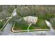 Aerial shot showcasing the home's location on a large corner lot with mature trees at 1031 Pomme De Pin Ln, New Port Richey, FL 34655