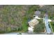 Aerial view of a suburban home and neighborhood surrounded by trees and greenery at 1031 Pomme De Pin Ln, New Port Richey, FL 34655