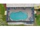 Aerial view of screened in pool and patio area at 1031 Pomme De Pin Ln, New Port Richey, FL 34655