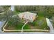 Aerial view of a suburban home with mature landscaping, a pool, and ample yard space at 1031 Pomme De Pin Ln, New Port Richey, FL 34655