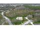 Aerial view of the home showcasing its location nestled amongst lush trees at 1031 Pomme De Pin Ln, New Port Richey, FL 34655