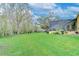 Expansive backyard with plenty of green space and mature trees at 1031 Pomme De Pin Ln, New Port Richey, FL 34655
