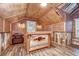 Unique bar room featuring brick walls, wood ceiling, and custom bar with corrugated metal accents at 1031 Pomme De Pin Ln, New Port Richey, FL 34655
