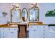 Coastal-themed bathroom with dual vanities, starfish accents, and stylish fixtures at 1031 Pomme De Pin Ln, New Port Richey, FL 34655
