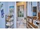Cozy bathroom showcases decorative accents and a rustic, vintage-style door at 1031 Pomme De Pin Ln, New Port Richey, FL 34655