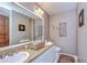 Bright bathroom with dual sinks, decorative mirrors, and updated fixtures, perfect for a modern lifestyle at 1031 Pomme De Pin Ln, New Port Richey, FL 34655