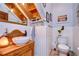 Unique bathroom featuring wooden accents, a vessel sink, and charming coastal decor at 1031 Pomme De Pin Ln, New Port Richey, FL 34655