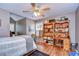 Inviting bedroom with ample shelving, a cozy reading nook, and natural light, perfect for relaxation at 1031 Pomme De Pin Ln, New Port Richey, FL 34655