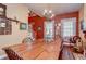 Spacious dining room featuring a large table, chandelier lighting, and traditional decor for elegant dining at 1031 Pomme De Pin Ln, New Port Richey, FL 34655