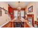 Warm dining room showcasing a brick fireplace, large dining table, and a blend of classic and rustic style at 1031 Pomme De Pin Ln, New Port Richey, FL 34655