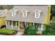 Inviting front porch with dormer windows providing curb appeal to this charming home at 1031 Pomme De Pin Ln, New Port Richey, FL 34655