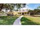 Charming two-story home with a welcoming front porch and meticulously landscaped front yard at 1031 Pomme De Pin Ln, New Port Richey, FL 34655