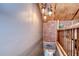 Rustic hallway with brick accents, wood paneling, and unique lighting fixtures at 1031 Pomme De Pin Ln, New Port Richey, FL 34655