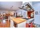 Open kitchen area featuring wood countertops, stainless steel appliances, and seamless flow to other living spaces at 1031 Pomme De Pin Ln, New Port Richey, FL 34655