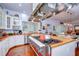 Gourmet kitchen with stainless steel range, wood countertops, island, and ample cabinet space at 1031 Pomme De Pin Ln, New Port Richey, FL 34655