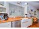 Bright kitchen with a farmhouse sink, wood countertops, and stainless steel appliances at 1031 Pomme De Pin Ln, New Port Richey, FL 34655