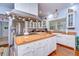 Spacious kitchen features stainless steel appliances, an island with a cooktop, and hardwood floors at 1031 Pomme De Pin Ln, New Port Richey, FL 34655