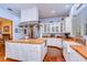 Bright kitchen with white cabinetry, stainless steel appliances, and butcher block countertops with ample prep space at 1031 Pomme De Pin Ln, New Port Richey, FL 34655