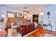 Inviting living room with brick fireplace, wood accents, and warm, natural lighting at 1031 Pomme De Pin Ln, New Port Richey, FL 34655