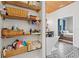 A bathroom featuring patterned tile flooring, wooden shelves, and a glimpse of the adjacent bedroom at 11151 Lu Wista Ln, Brooksville, FL 34601