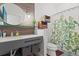 Bathroom featuring a stylish vanity with baskets and a decorative shower curtain at 11151 Lu Wista Ln, Brooksville, FL 34601