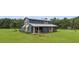 Charming two-story home with a metal roof and a large, well-maintained yard at 11151 Lu Wista Ln, Brooksville, FL 34601