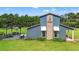 Charming blue home featuring a name plate, covered patio, and ample space for outdoor activities at 11151 Lu Wista Ln, Brooksville, FL 34601