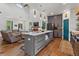 Open concept kitchen with marble island, gray cabinets, stainless steel appliances, and high ceilings at 11151 Lu Wista Ln, Brooksville, FL 34601