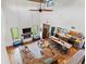 Open concept living room with fireplace, high ceilings, and views of kitchen, dining room, and stairwell at 11151 Lu Wista Ln, Brooksville, FL 34601