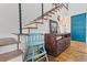Staircase with modern cable railing, wood treads, and stylish decor accents at 11151 Lu Wista Ln, Brooksville, FL 34601