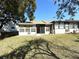 Backyard with a well-maintained lawn and mature trees at 11737 Spring Tree Ln, Port Richey, FL 34668