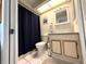 Bathroom with a toilet, tub and vanity with framed mirror at 11737 Spring Tree Ln, Port Richey, FL 34668