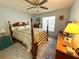 Traditional bedroom with a four-poster bed, ceiling fan, and neutral décor at 11737 Spring Tree Ln, Port Richey, FL 34668