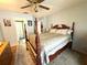Traditional bedroom featuring a four-poster bed with an ensuite bathroom at 11737 Spring Tree Ln, Port Richey, FL 34668