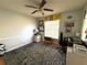 Bedroom featuring a large window, hardwood floors, and ceiling fan at 11737 Spring Tree Ln, Port Richey, FL 34668