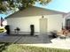 Charming home exterior featuring a quaint front door and well-manicured landscaping at 11737 Spring Tree Ln, Port Richey, FL 34668