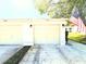 Two-car garage with traditional doors and an American flag flying nearby at 11737 Spring Tree Ln, Port Richey, FL 34668
