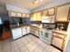 Functional kitchen with tile flooring and white appliances at 11737 Spring Tree Ln, Port Richey, FL 34668