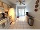 Bright kitchen with white appliances, tile flooring and ceiling fan at 11737 Spring Tree Ln, Port Richey, FL 34668