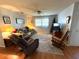 Bright living room features natural light, a ceiling fan, and comfortable furnishings at 11737 Spring Tree Ln, Port Richey, FL 34668