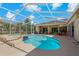 Enclosed in-ground pool and spa with ample patio space for lounging and entertaining near the home at 1212 Halifax Ct, Tarpon Springs, FL 34688