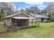 Spacious backyard showcases a covered outdoor area, perfect for relaxation or entertaining guests at 13289 Joy Path, Brooksville, FL 34601
